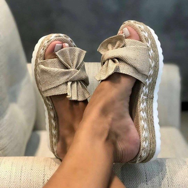 Wedge sandals for women featuring a stylish bow detail, cushioned comfort, and an elegant woven design, perfect for summer outings. 0