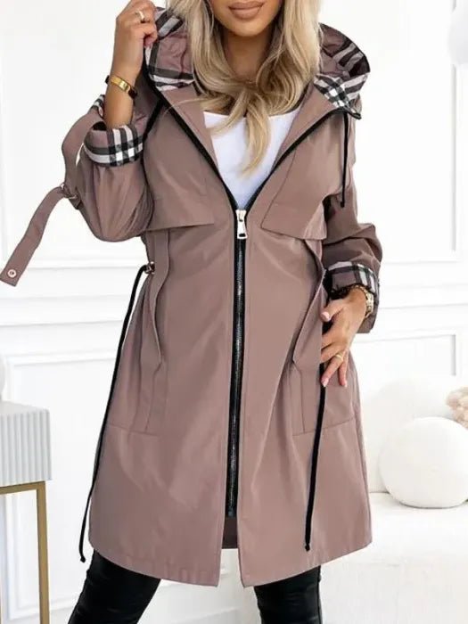 Women's waterproof trench coat featuring a hood and stylish plaid lining, designed for windproof protection and lightweight comfort in winter weather. 0