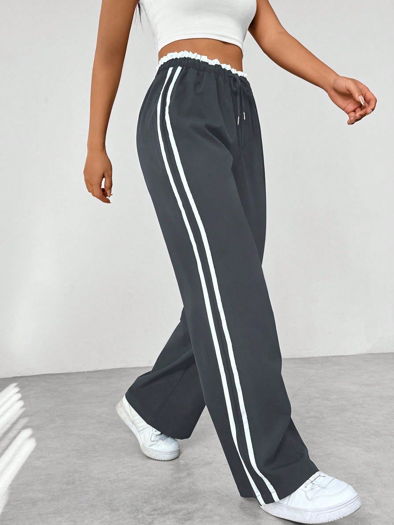Women's wide leg trousers featuring sporty side stripes, designed for airy comfort and casual style in spring. 3