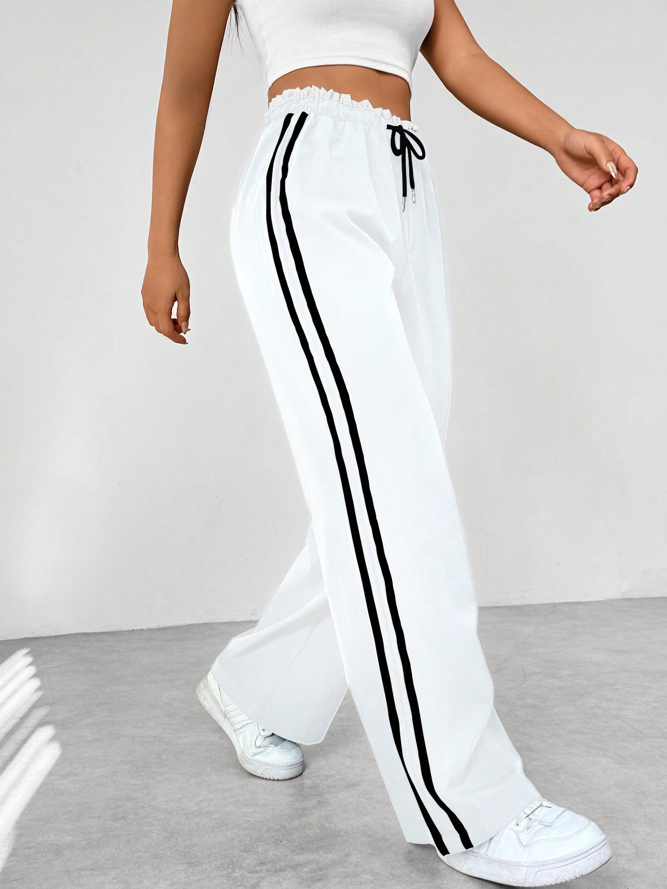 Women's wide leg trousers featuring sporty side stripes, designed for airy comfort and casual style in spring. 4