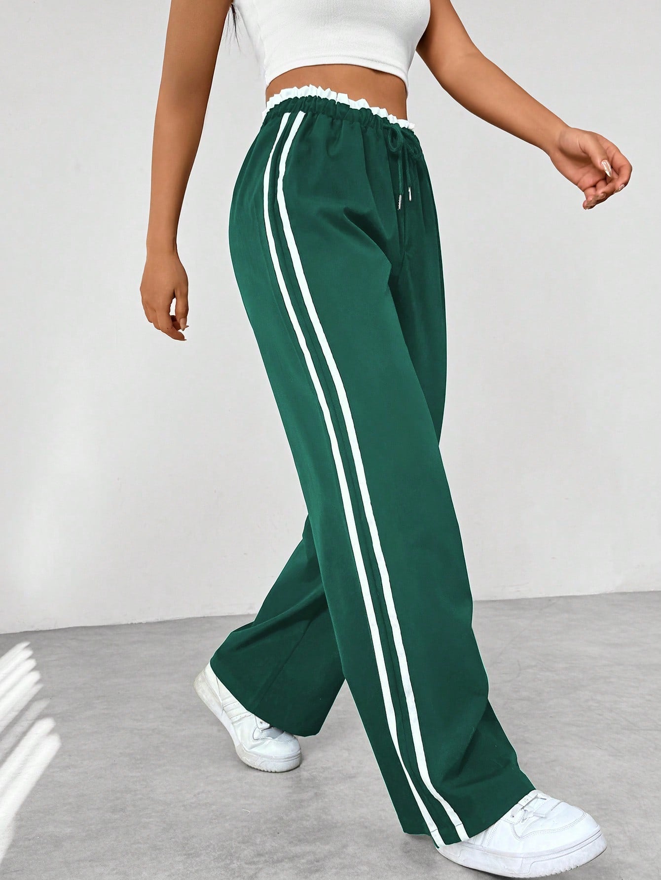 Women's wide leg trousers featuring sporty side stripes, designed for airy comfort and casual style in spring. 6