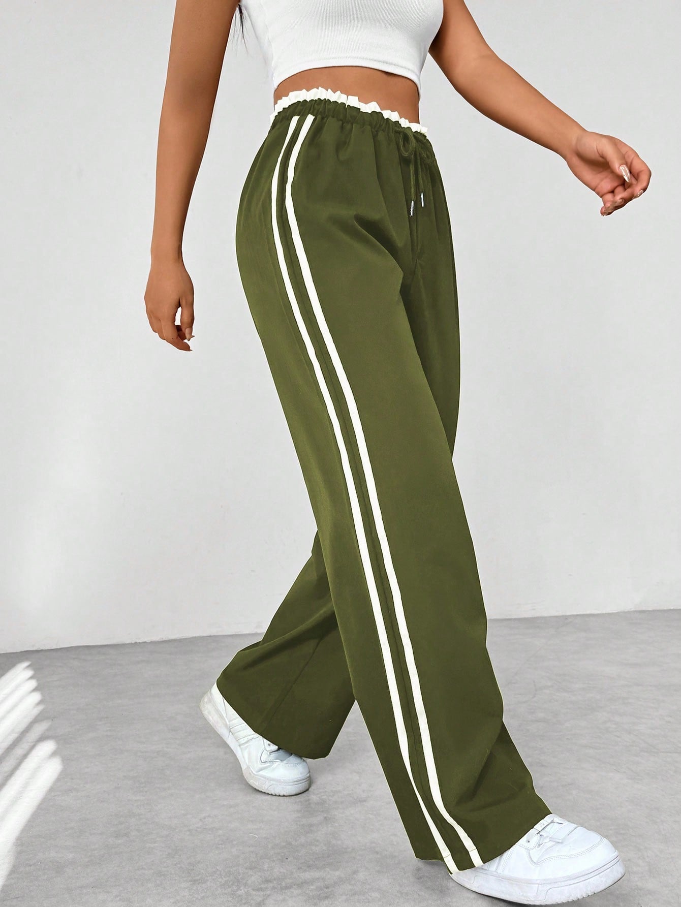 Women's wide leg trousers featuring sporty side stripes, designed for airy comfort and casual style in spring. 7