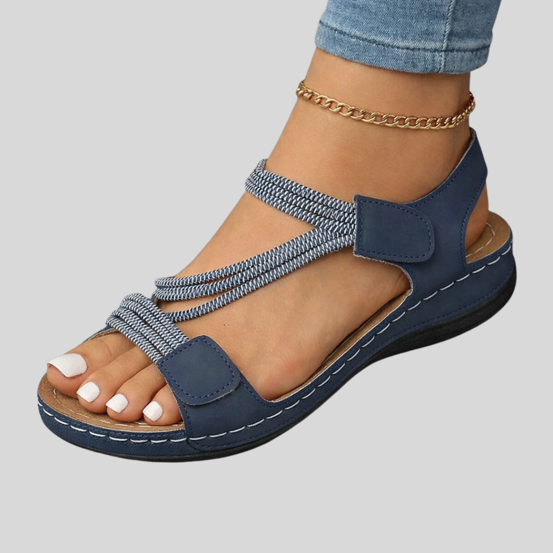 Lightweight orthopedic sandals for women featuring a cushioned footbed and adjustable straps, designed with a modern strappy look for comfort and style. 1