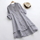 Linen shirt dress with asymmetric layered hem, featuring a versatile button-down design, perfect for summer wear in plus sizes. 4