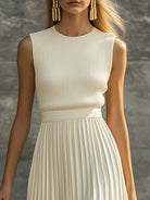 Maxi dress featuring a sleeveless knit bodice and a flowing pleated chiffon hem, designed for women in an elegant cream color. 2