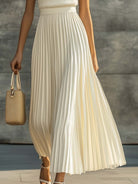 Maxi dress featuring a sleeveless knit bodice and a flowing pleated chiffon hem, designed for women in an elegant cream color. 3