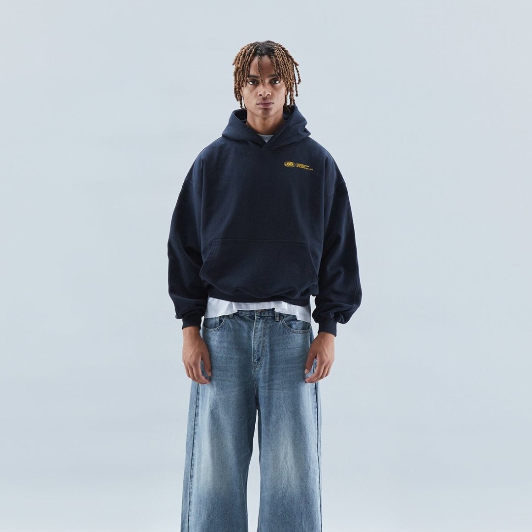 Oversized hoodie featuring a stylish graphic design, made from heavyweight cotton-blend fleece, showcasing modern streetwear style with a convenient kangaroo pocket. 2