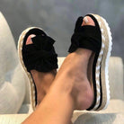Wedge sandals for women featuring a stylish bow detail, cushioned comfort, and an elegant woven design, perfect for summer outings. 1