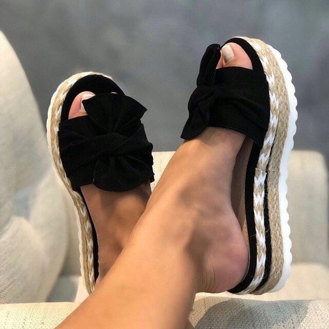 Wedge sandals for women featuring a stylish bow detail, cushioned comfort, and an elegant woven design, perfect for summer outings. 1