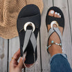White flat sandals for women featuring a stylish metal buckle, designed for comfort and easy slip-on wear, perfect for summer outings. 1