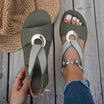 White flat sandals for women featuring a stylish metal buckle, designed for comfort and easy slip-on wear, perfect for summer outings. 2