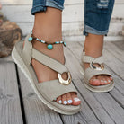 White flat sandals for women featuring a stylish metal buckle, designed for comfort and easy slip-on wear, perfect for summer outings. 4