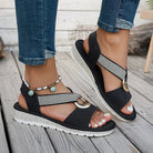 White flat sandals for women featuring a stylish metal buckle, designed for comfort and easy slip-on wear, perfect for summer outings. 6