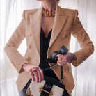 Women's double-breasted black blazer with structured fit, featuring stylish gold buttons, designed for a flattering silhouette, available in plus sizes. 6