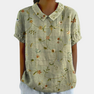 Women's blouse featuring a stylish Peter Pan collar, made from breathable fabric for comfort, designed in a loose fit for a chic summer look. 1