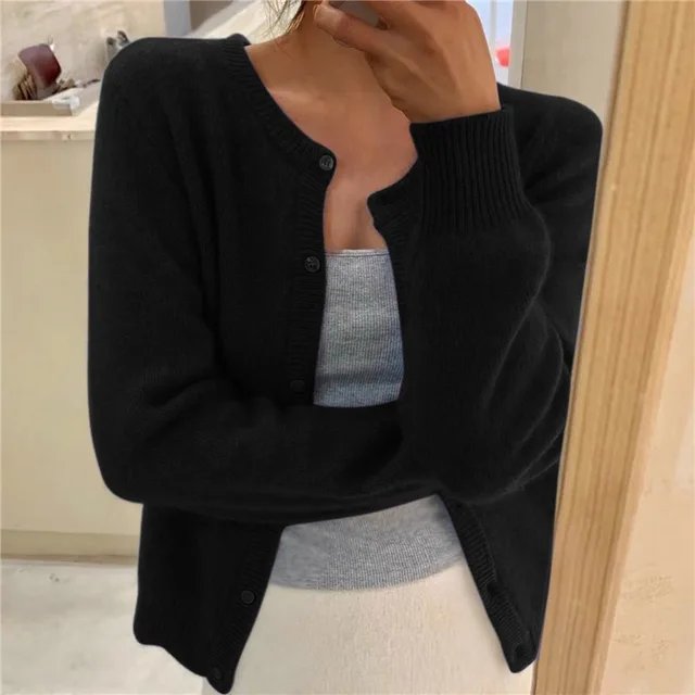 Women's cropped cardigan in white with button front, featuring a soft knit fabric and relaxed fit, perfect for layering in any season. 1