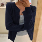 Women's cropped cardigan in white with button front, featuring a soft knit fabric and relaxed fit, perfect for layering in any season. 8