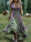 Women's floral maxi dress featuring a v-neck and short sleeves, designed with an elegant purple and blue print, perfect for summer events. 1