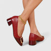 Women's croc-embossed patent leather loafers with block heel and stylish chain detail in a glossy finish. 1