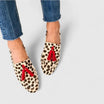 Women's leopard print loafers featuring orthopedic support and a convenient slip-on design, adorned with stylish red tassel accents. 0