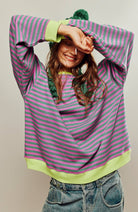Women's oversized sweatshirt featuring neon contrast trim, striped drop-shoulder design, and made from lightweight knit fabric, perfect for casual and comfortable wear. 0