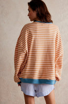 Women's oversized sweatshirt featuring neon contrast trim, striped drop-shoulder design, and made from lightweight knit fabric, perfect for casual and comfortable wear. 7