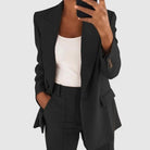 Elegant women's suit featuring a tailored blazer and high-waist trousers, perfect for office wear, showcasing a sophisticated design in a chic color palette. 0
