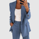 Elegant women's suit featuring a tailored blazer and high-waist trousers, perfect for office wear, showcasing a sophisticated design in a chic color palette. 4