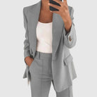 Elegant women's suit featuring a tailored blazer and high-waist trousers, perfect for office wear, showcasing a sophisticated design in a chic color palette. 5