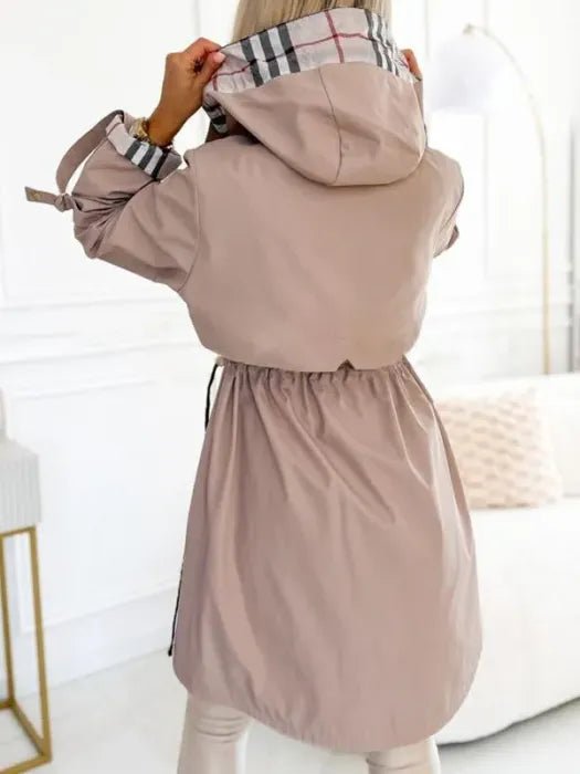 Women's waterproof trench coat featuring a hood and stylish plaid lining, designed for windproof protection and lightweight comfort in winter weather. 3