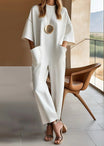 Women's black wide leg jumpsuit featuring a crew neck, short sleeves, and convenient pockets, designed for a relaxed fit and effortless style. 0