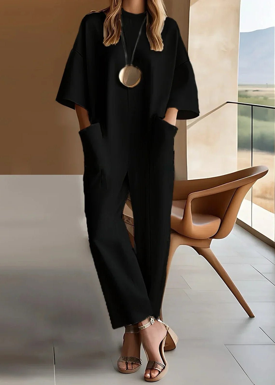 Women's black wide leg jumpsuit featuring a crew neck, short sleeves, and convenient pockets, designed for a relaxed fit and effortless style. 1