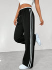 Women's wide leg trousers featuring sporty side stripes, designed for airy comfort and casual style in spring. 2