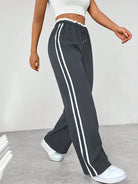Women's wide leg trousers featuring sporty side stripes, designed for airy comfort and casual style in spring. 3
