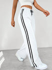Women's wide leg trousers featuring sporty side stripes, designed for airy comfort and casual style in spring. 4