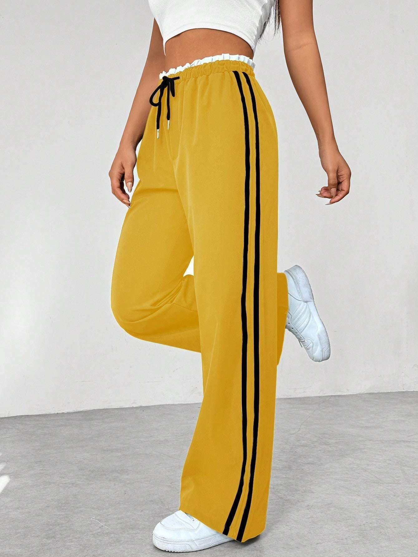 Women's wide leg trousers featuring sporty side stripes, designed for airy comfort and casual style in spring. 5