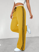 Women's wide leg trousers featuring sporty side stripes, designed for airy comfort and casual style in spring. 5