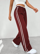 Women's wide leg trousers featuring sporty side stripes, designed for airy comfort and casual style in spring. 8