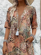 Womens summer dress featuring a V-neck design and a vibrant floral pattern, knee-length, made from soft fabric, and includes convenient side pockets. 5