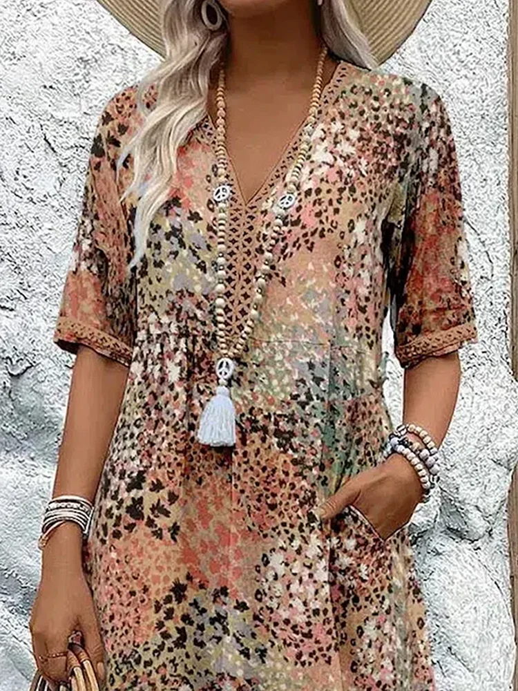 Womens summer dress featuring a V-neck design and a vibrant floral pattern, knee-length, made from soft fabric, and includes convenient side pockets. 5