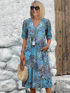 Womens summer dress featuring a V-neck design and vibrant floral pattern, knee-high length, comfortable fit, and plus sizes available for a stylish and flattering 1