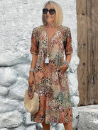 Womens summer dress featuring a V-neck design and vibrant floral pattern, knee-high length, comfortable fit, and plus sizes available for a stylish and flattering 4